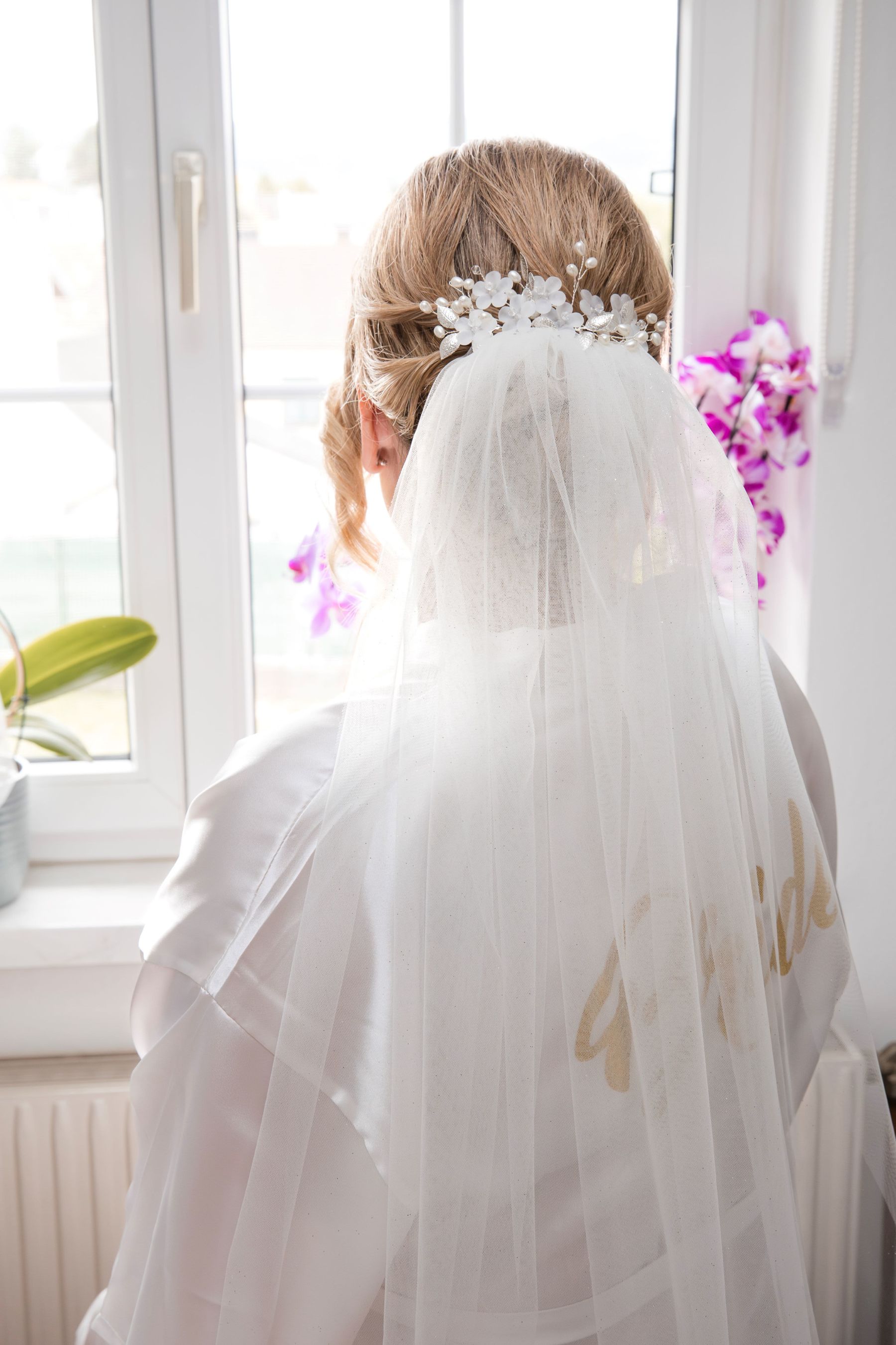Braut mit Brautschleier beim Getting Ready